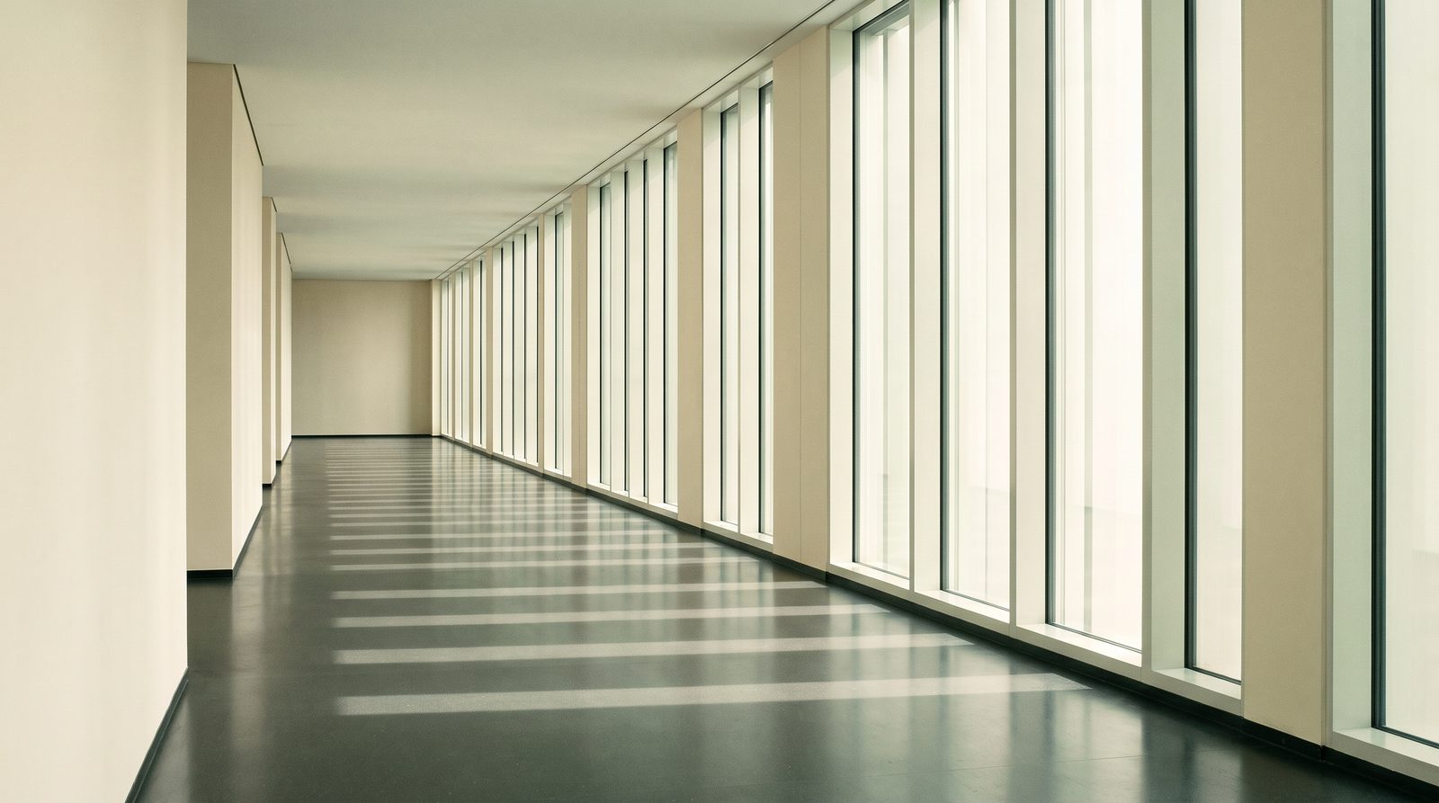 A long, light-filled corridor in a modern building